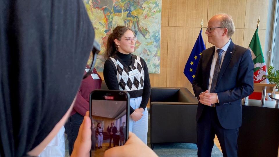 Eine Schülerin fotografiert eine weitere Schülerin und Landtagspräsident Kuper im Landtag. Eine Schülerin fotografiert eine weitere Schülerin und Landtagspräsident Kuper im Landtag.