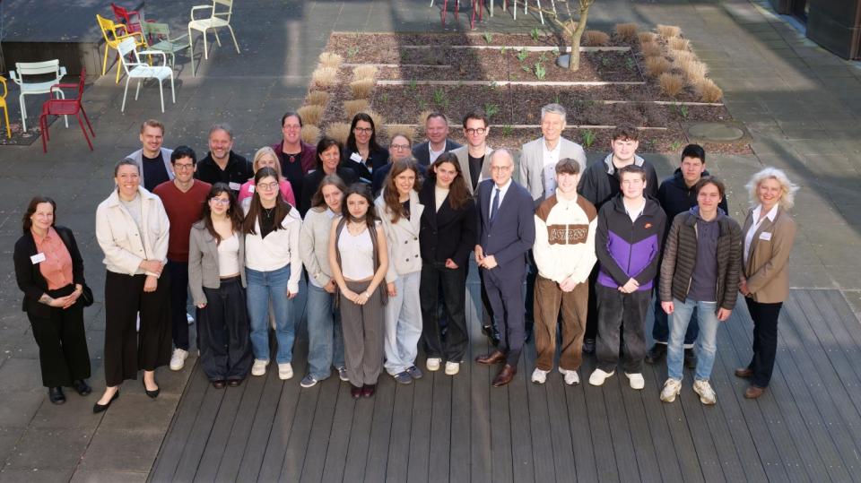 Schülerinnen und Schüler mit Mentorinnen und Mentoren im Innenhof des MSB NRW