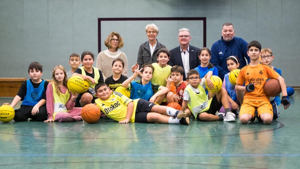 Gruppenbild mit Ministerin Feller und Schülerinnen und Schülern der GGS Kunterbunt Duisburg 