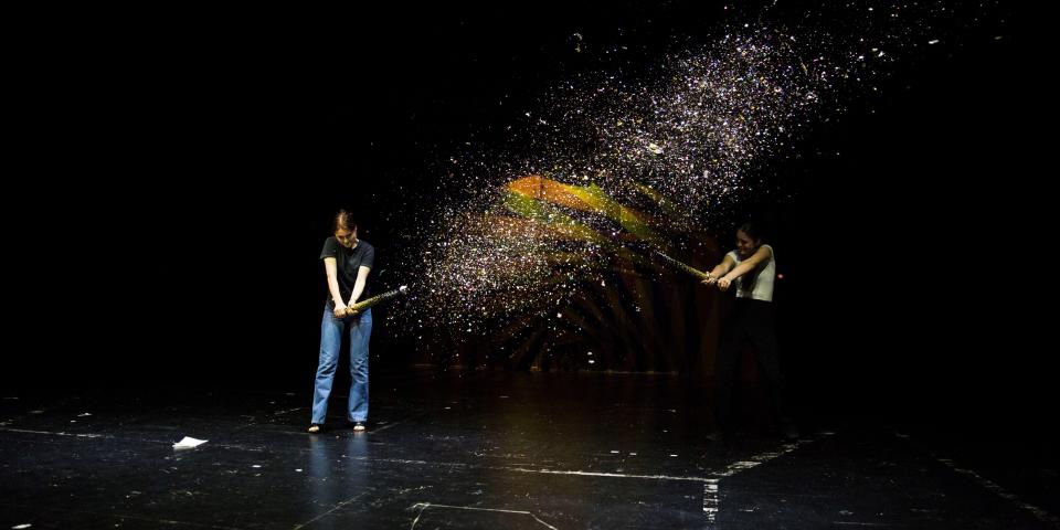 Zwei Schülerinnen schießen auf der Bühne mit riesigen Konfetti-Kanonen.