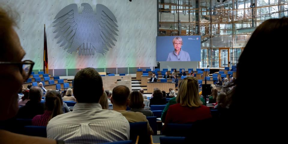 Grundschulleitertag im WCC in Bonn, auf einem großen Bildschirm erscheint das Begrüßungsvideo von Ministerin Feller (25. März 2026)