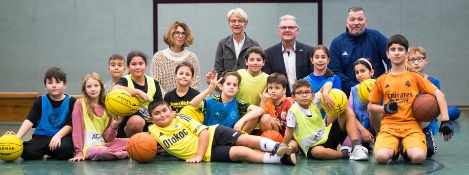Gruppenbild mit Ministerin Feller und Schülerinnen und Schülern der GGS Kunterbunt Duisburg 